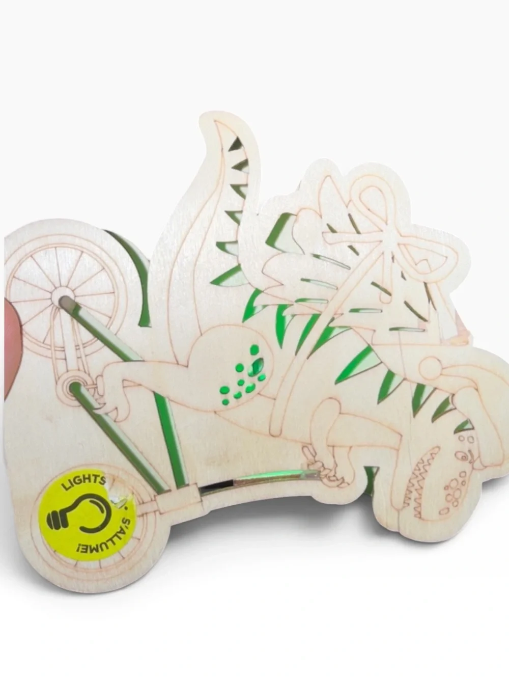 Cut out wood Dino on bike carrying a Christmas tree,